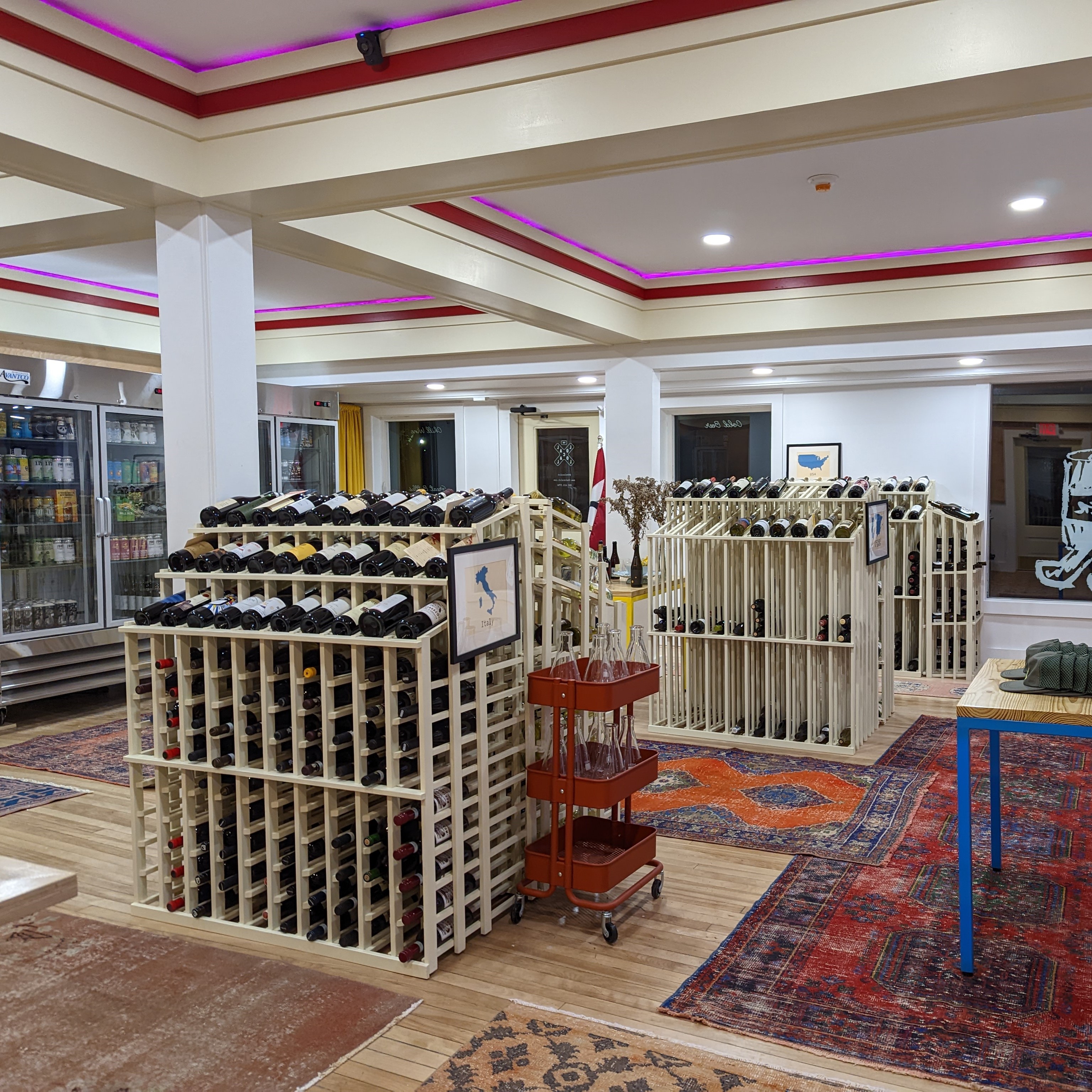 Well-lit wine cellar with diamond-shaped wine racks filled with bottles